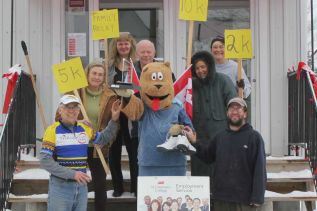 The competition is already heating up for this year’s Heritage Festival Walk/Run. Rudy Hollywood (left), the 2012 winner, and Jeff Green (right) the 2011 winner, both reach for the trophy, which is being held by Heri-Bear. “It would make a good murder weapon,” said Green of the heavy trophy. He announced that if he wrests it from Hollywood this year, it could become the inspiration for a summer murder mystery series.